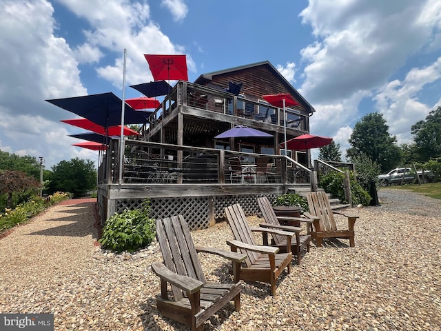 rear view of property with a deck and stairs