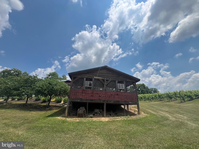 rear view of property with a deck and a lawn