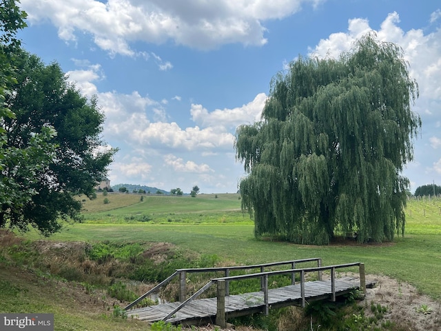 view of home's community with a deck and a rural view