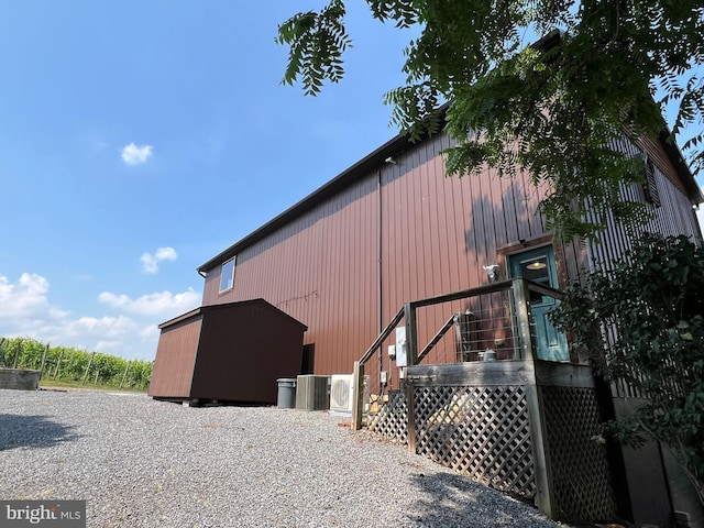 view of home's exterior featuring an outbuilding and cooling unit