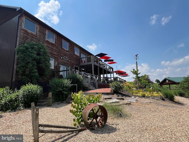 exterior space featuring stairway and a wooden deck