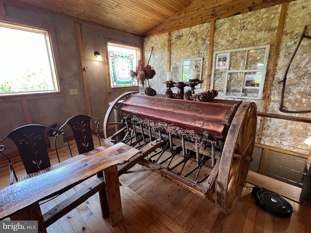 dining space featuring lofted ceiling, hardwood / wood-style flooring, and wooden ceiling