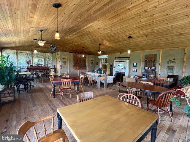 dining space featuring lofted ceiling, hardwood / wood-style floors, ceiling fan, and wood ceiling