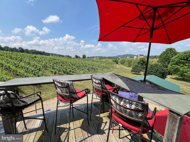 wooden deck with a rural view