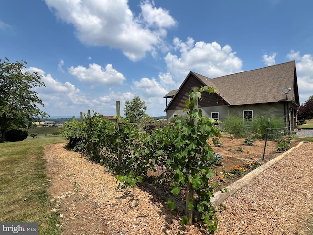 view of home's exterior with a shingled roof