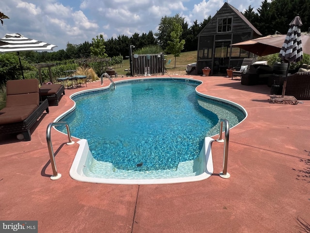 view of swimming pool with a patio area