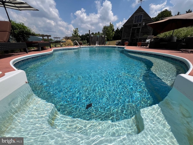 view of swimming pool featuring a patio area