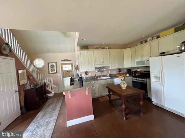 kitchen with a breakfast bar area, sink, white appliances, and white cabinetry