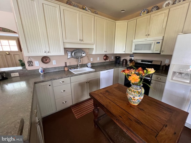 kitchen featuring a sink, white appliances, and dark countertops