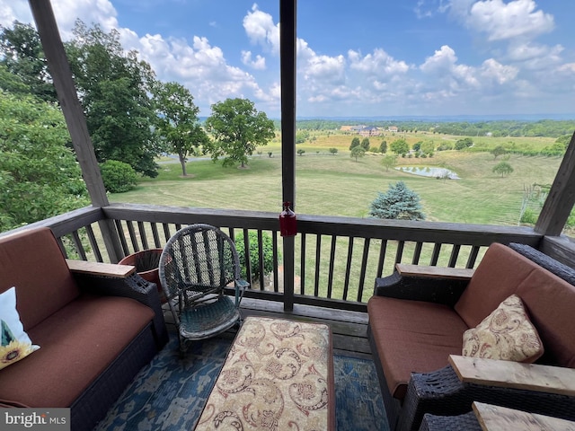 wooden deck with a yard and a rural view