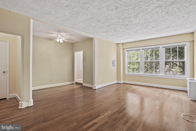 spare room featuring wood-type flooring, ceiling fan, and a textured ceiling