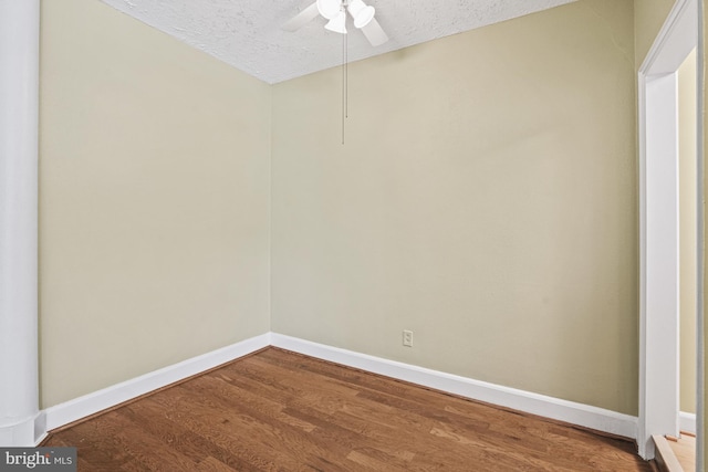 empty room featuring hardwood / wood-style flooring and a textured ceiling