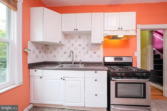 kitchen featuring white cabinets, sink, light hardwood / wood-style flooring, and stainless steel range with gas cooktop