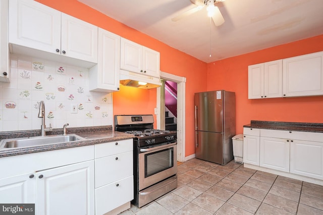 kitchen featuring appliances with stainless steel finishes, white cabinets, light tile patterned floors, ceiling fan, and sink