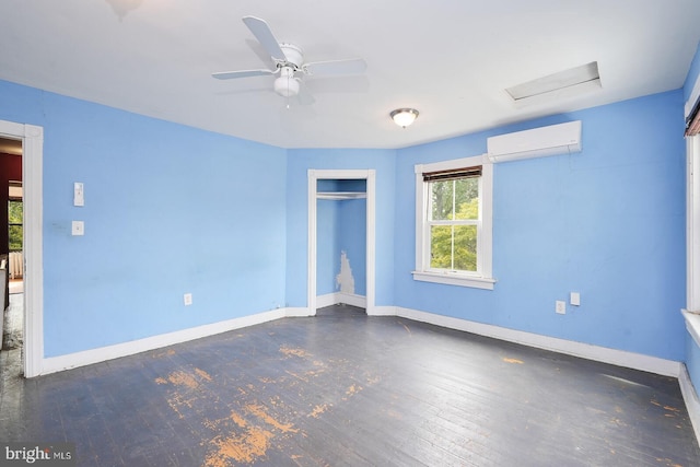 unfurnished room featuring an AC wall unit, dark wood-type flooring, and ceiling fan