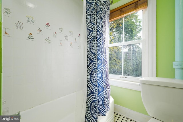 bathroom with toilet and tile patterned floors