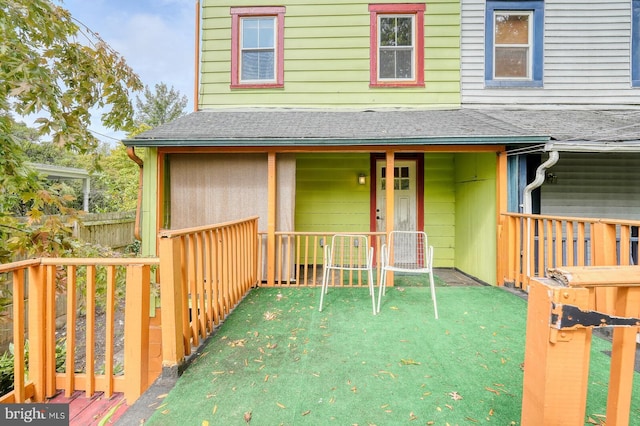 entrance to property with a lawn