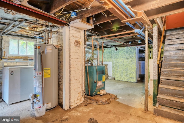 basement with water heater and washer / dryer