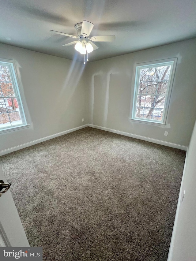 empty room featuring baseboards, carpet floors, and a healthy amount of sunlight