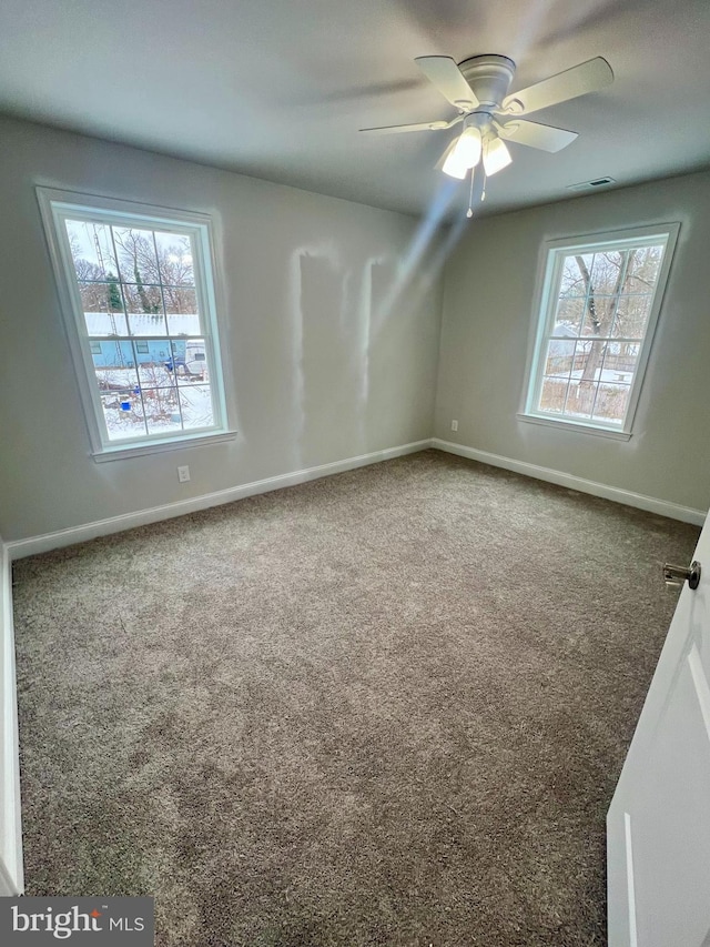 bonus room featuring a wealth of natural light, visible vents, carpet floors, and baseboards