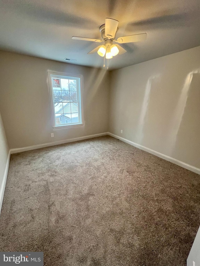 unfurnished room featuring visible vents, baseboards, a textured ceiling, and carpet flooring