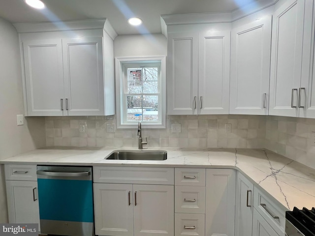 kitchen with dishwasher, white cabinetry, and a sink