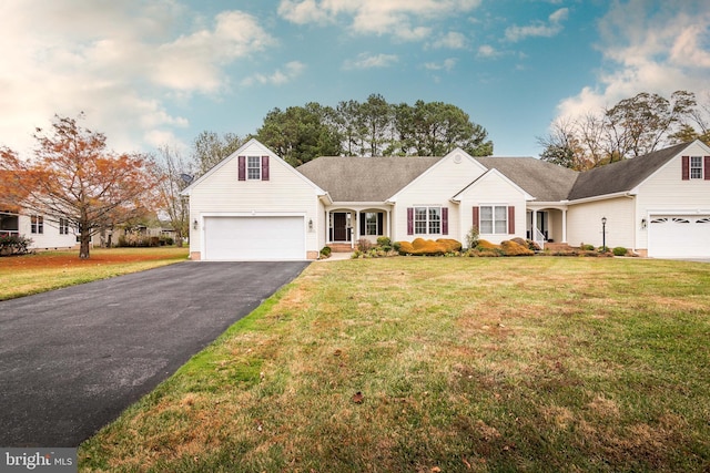 view of front of home featuring aphalt driveway, an attached garage, and a front yard