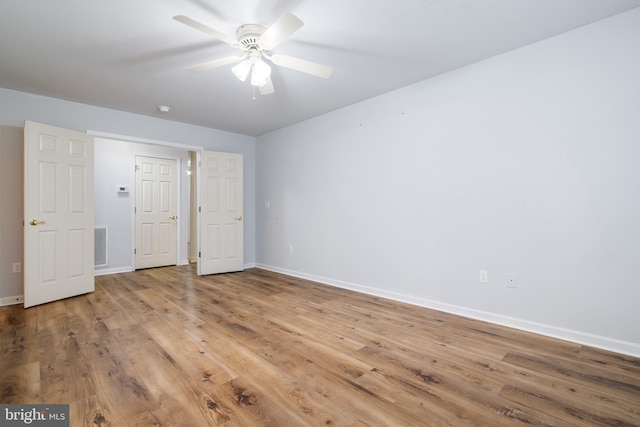 unfurnished bedroom with ceiling fan and light wood-type flooring