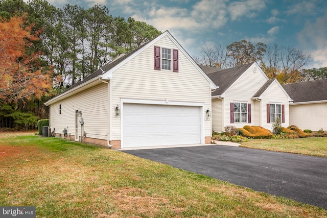 view of front facade featuring aphalt driveway, a garage, cooling unit, and a front lawn