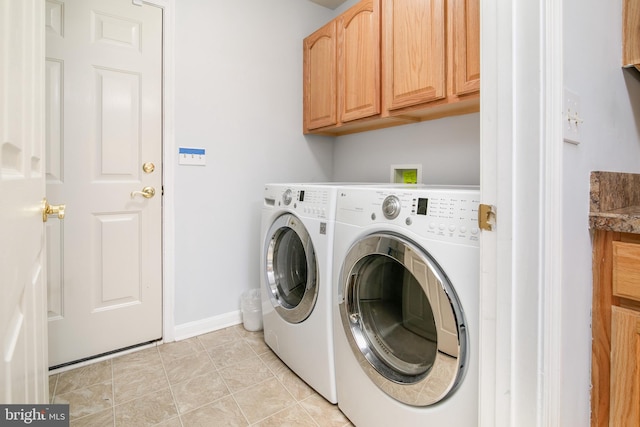 laundry area with separate washer and dryer, light tile patterned flooring, and cabinets