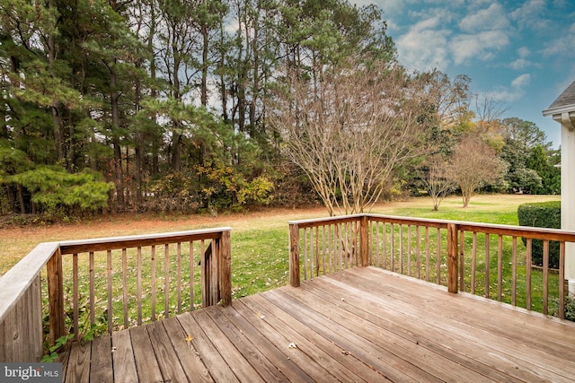 wooden terrace featuring a lawn