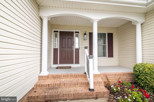 view of exterior entry featuring a porch