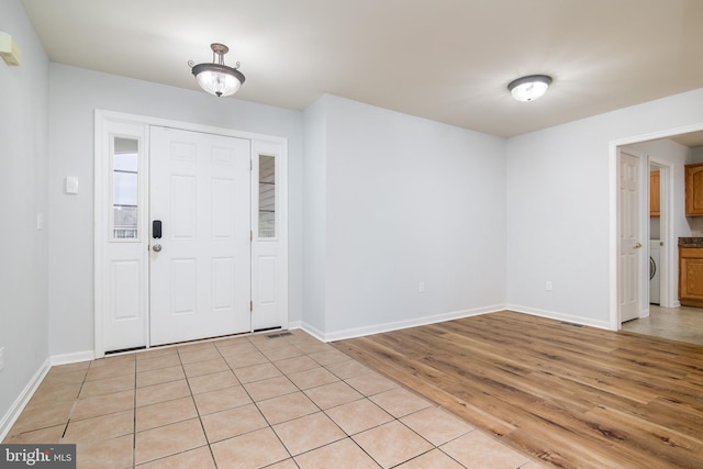 entryway with baseboards and light wood-style floors