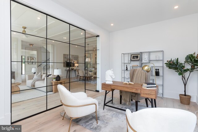 office space with ceiling fan and light hardwood / wood-style floors