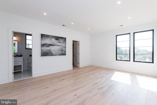 spare room with plenty of natural light and light wood-type flooring