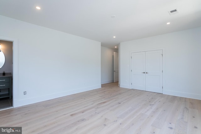 unfurnished room with light hardwood / wood-style floors