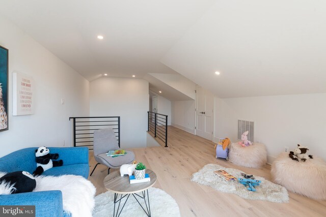 interior space with lofted ceiling and light hardwood / wood-style flooring