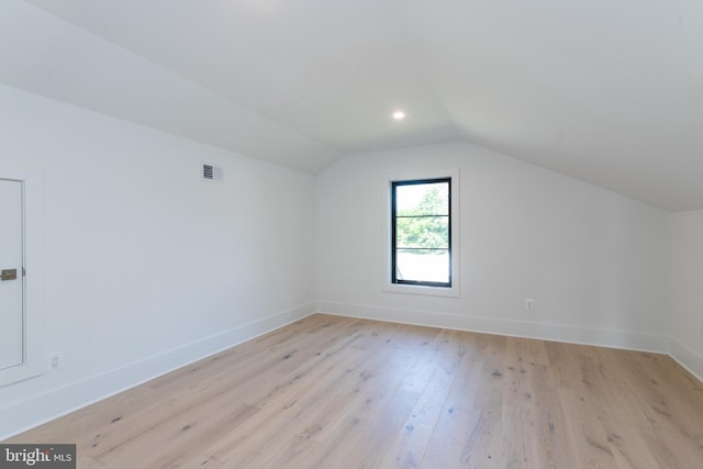 additional living space with lofted ceiling and light wood-type flooring