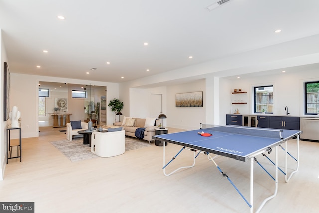 game room featuring light wood-type flooring