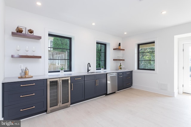 bar with dishwasher, beverage cooler, sink, and light hardwood / wood-style floors