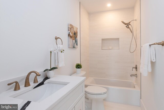 full bathroom with toilet, tiled shower / bath combo, and vanity