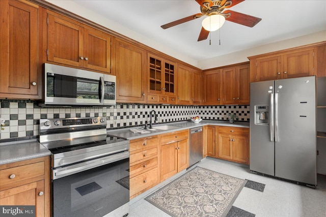 kitchen featuring tasteful backsplash, ceiling fan, sink, and stainless steel appliances