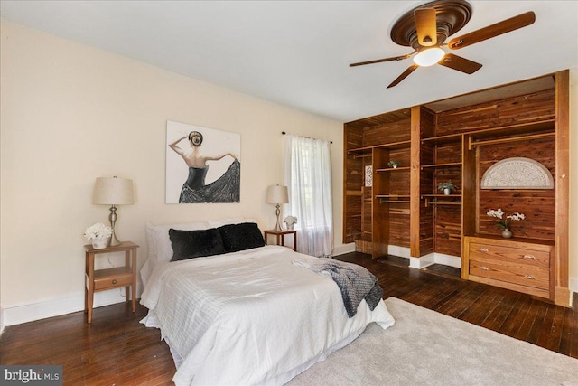 bedroom with ceiling fan and dark wood-type flooring