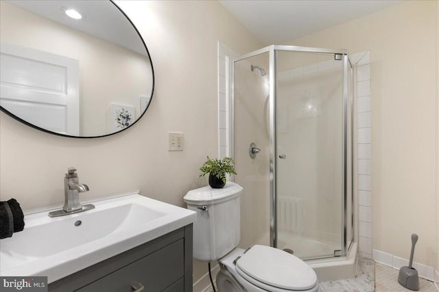 bathroom with tile patterned flooring, vanity, toilet, and a shower with shower door