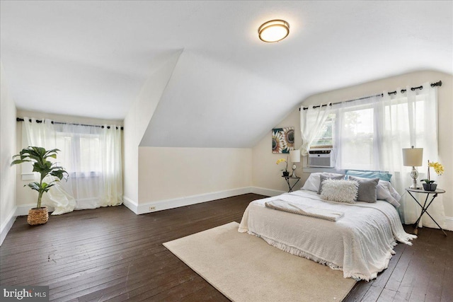 bedroom featuring dark hardwood / wood-style floors, vaulted ceiling, and cooling unit