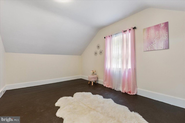 bonus room featuring dark wood-type flooring and vaulted ceiling