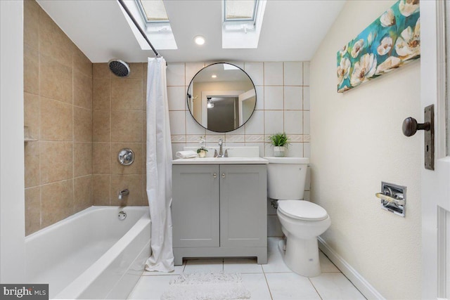 full bathroom featuring shower / bath combo, a skylight, vanity, tile patterned flooring, and toilet