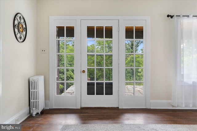 entryway with radiator and dark hardwood / wood-style flooring