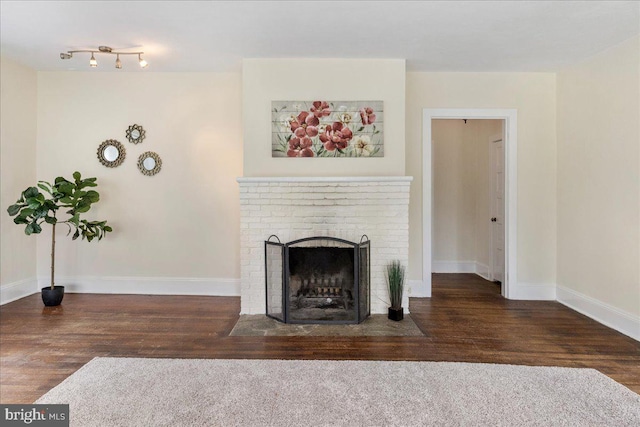 unfurnished living room with a fireplace and dark wood-type flooring