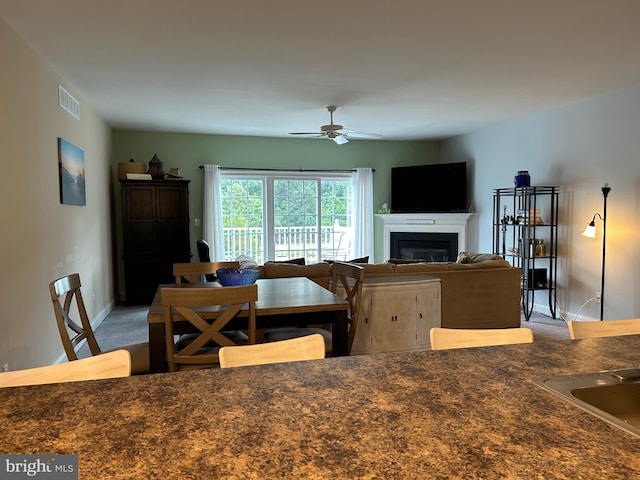 kitchen featuring ceiling fan and carpet floors